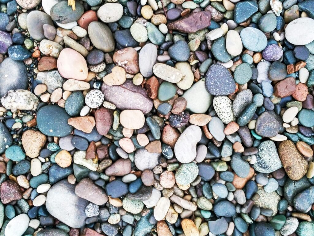 Vibrant collection of smooth, multicolored pebbles and stones arranged closely.